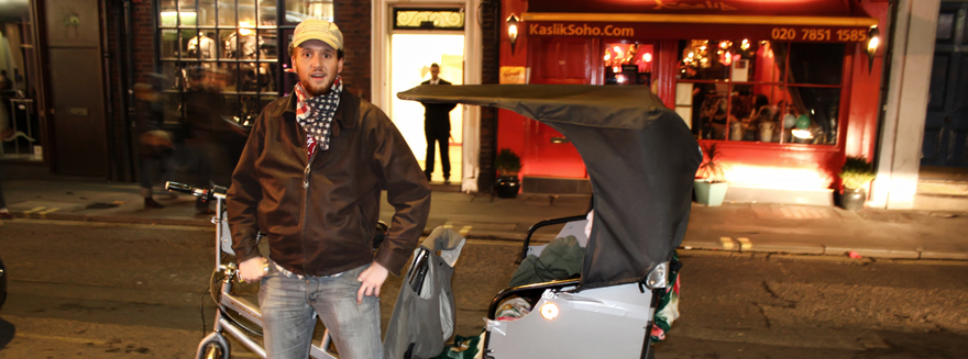 A Bugbugs rider posing with pedicab during the evening shift at work in Soho, Central London